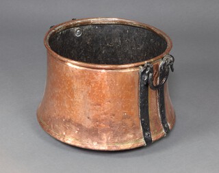 A large circular copper twin handled urn with iron drop handles 38cm h x 51cm diam. 