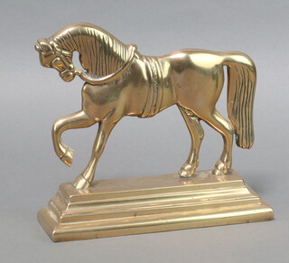 A brass door stop in the form of a walking horse 21cm h x 24cm w x 7cm d 