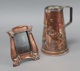 A Sankey and Sons embossed copper jug 21cm x 8cm (lid missing), together with a planished copper easel photograph frame 16cm x 13cm 