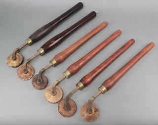 Six circular wooden handled leather embossing skiver wheels