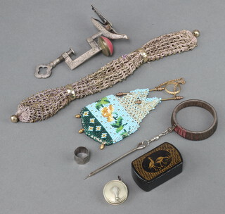 A 19th Century polished steel embroidery clamp decorated a bird, a purse, a small snuff box and minor curios 