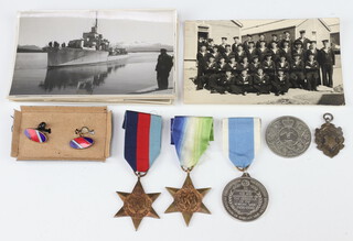 A 1939-45 Star, an Atlantic Star , an unofficial medal to commemorate the 40th Anniversary of the outbreak of the Korean War, a silver watch chain medallion, 1977 Silver Jubilee crown, a pair of enamelled RAF cufflinks and various postcard of naval scenes 