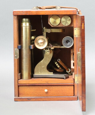 J H Steward, 106 Strand London, a student's 19th Century brass single pillar microscope together with 21 various microscopic slides, contained in a mahogany case 