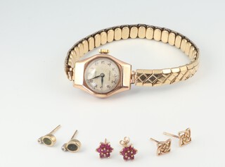 Three pairs of 9ct yellow gold ear studs and a lady's 9ct yellow gold cased wristwatch, 2.1 grams weighable 