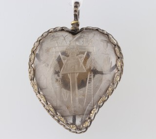 A 17th Century gilt metal mounted heart shaped rock crystal pendant with interior engraved motifs and an inset reliquary (empty) 5.5cm 