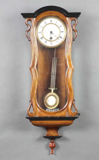 A Continental regulator style timepiece with 14cm enamelled dial, Roman numerals and grid iron pendulum, contained in a shaped walnut case 76cm h x 28cm w x 13cm d 