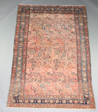 A pink, blue and green ground Caucasian style rug decorated birds amidst flowers within a 3 row border 191cm x 136cm 