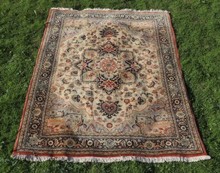 A cream ground and floral patterned Persian style machine made rug with central medallion 280cm x 198cm 