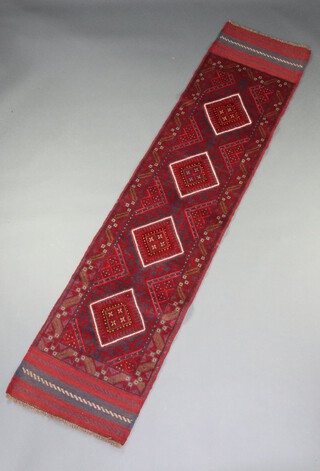 A blue and red ground Meshwani runner with 4 diamonds to the centre 244cm x 57cm 