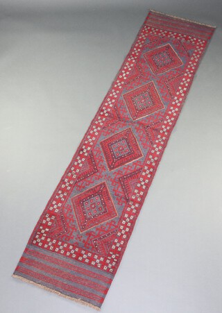 A red and blue ground Meshwani runner with 4 stylised diamonds to the centre 249cm x 58cm 