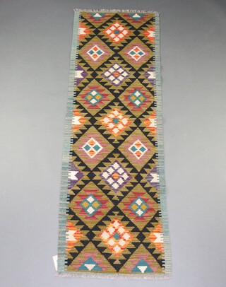 A black, brown and green ground Meshwani Kilim runner with all over diamond design 200cm x 63cm 