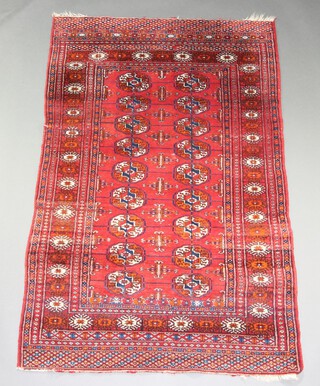 A red and blue ground Bokhara rug with 18 octagons to the centre 163cm x 106cm 