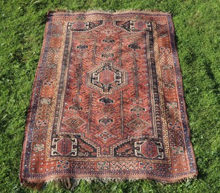 A red, brown and white ground Persian rug with central medallion within a multi row border 232cm x 148cm 