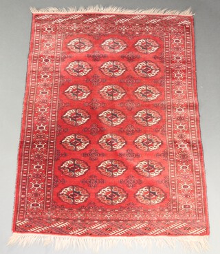 A red, blue and white ground Afghan rug with 21 octagons within a multi row border 156cm x 114cm  