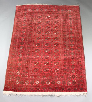 A black and red ground Afghan rug with 30 octagons to the centre within a multi row border 186cm  x 135cm 