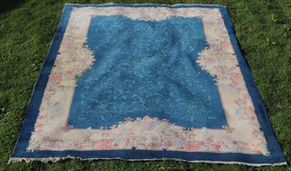 A 1930's blue and cream patterned Chinese carpet 331cm x 246cm 