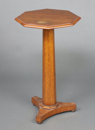 A William IV octagonal oak pedestal table raised on a chamfered column and triform base 76cm h x 45cm w x 45cm d 