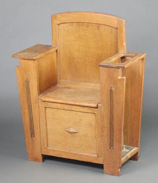 An Art Deco bleached oak hall seat with hinged lid, fitted an umbrella stand to one side and newspaper rack to the other 95cm h x 78cm w x 31cm d 