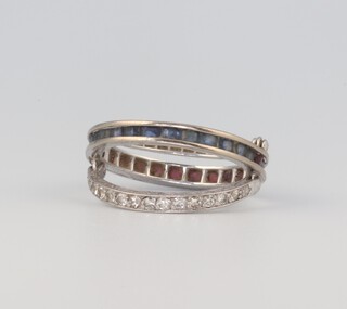 A white metal fold over eternity ring comprising 1 band of diamonds, half a band of rubies and half a band of sapphires, size P, 5.7 grams 