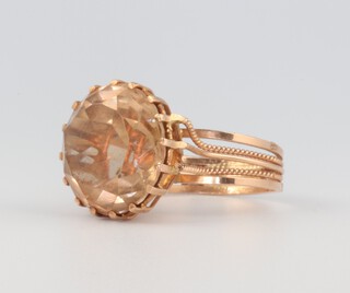 An Egyptian yellow metal dress ring set with a brilliant cut quartz stone, size O 1/2 