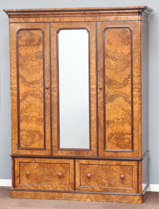 H Hobden of Manchester, a Victorian figured walnut triple wardrobe with moulded cornice, the centre section fitted a hanging shelf enclosed by a panelled and arch plate mirrored door, the right hand section fitted 3 slides above 2 short drawers, the base fitted 2 drawers marked Hobden Manchester 3549  220cm h x 168cm w x 62cm d 