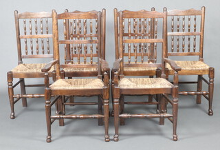 A set of 6 17th Century style elm spindle back dining chairs comprising 2 carvers 104cm h x 57cm w x 44cm d  and 4 standard chairs 98cm h x 46cm w x 37cm d, raised on turned supports with turned stretchers