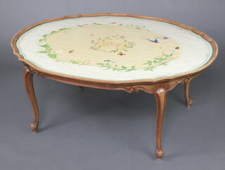 A French painted oval walnut coffee table, the centre section marked HL with floral garlands and butterflies, raised on cabriole supports 53cm h x 125cm w x 98cm d 