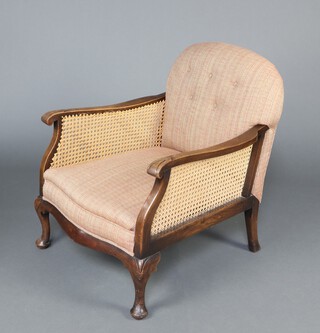 A 1930's mahogany framed single cane bergere armchair, the seat and back upholstered in patterned material  77cm h x 65cm w x 66cm d (seat 33cm x 41cm) 