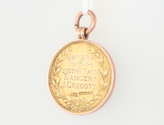 Of Football Interest. A 9ct yellow gold football medallion King Edward (Ealing) Hospital Cup, Winners 1913-14 Queen's Park Rangers. J.Gregory, boxed 8.6 grams (John known as Jack Gregory played for Queens Park Rangers 1912 - 1923 returning to them after WWI)