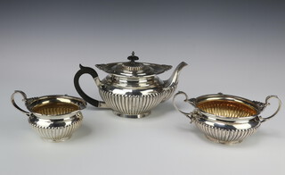 An Edwardian silver 3 piece tea set with demi-fluted decoration and scroll egg and dart rim, Sheffield 1903, gross weight 1248 grams 