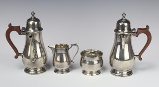 A Queen Anne style 4 piece silver coffee set comprising coffee pot, hot water jug (both with wooden mounts), cream jug and sugar bowl, Sheffield 1934, 882 grams 