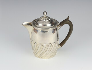 An Edwardian, Georgian style silver hot water jug with demi-fluted decoration and fruit wood handle,  London 1903, 445 grams gross