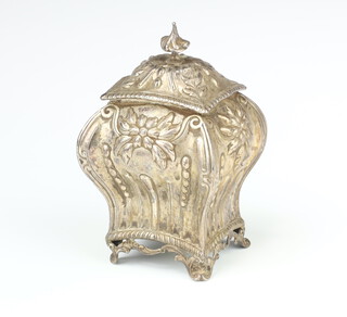 An Edwardian repousse silver bombe shape tea caddy with floral decoration on scroll feet Sheffield 1901, 291 grams 