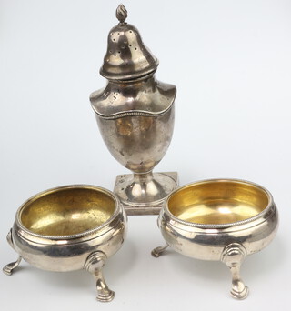 An Edwardian silver Georgian style pepperette London 1901, a pair of Georgian silver table salts on hoof feet (rubbed marks) 181 grams 