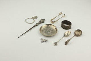 A coin set white metal circular dish, 2 spoons, a pair of sugar nips and 4 other items