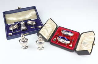 A silver 3 piece condiment with spoons, cased, Birmingham 1961, a 2 piece ditto and 2 pepperettes, weighable silver 288 grams 