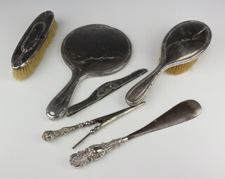 A silver backed hand mirror Birmingham 1912, hair brush, clothes brush, comb mount, shoe horn and glove stretchers 