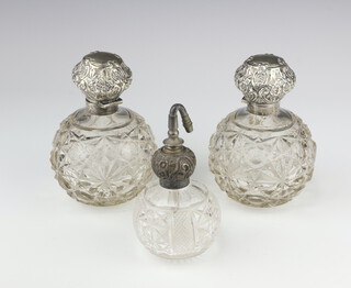 A pair of Edwardian silver mounted spherical scent bottles, Sheffield 1908 14cm, ditto atomiser 