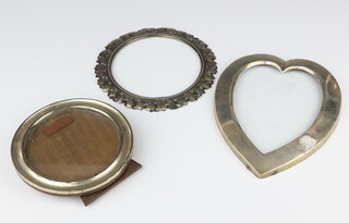 An Edwardian silver heart shaped photograph frame London 1900 (with glass but no back), a circular ditto 15cm and a complete circular ditto Birmingham 1917 