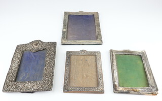 An Edwardian silver photograph frame with arched top and vacant cartouche Birmingham 1903 23cm and 3 other frames 