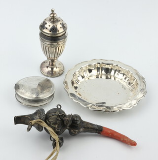 A circular silver pin dish Sheffield 1946, a pill box, pepper and child's rattle, weighable silver 78 grams 