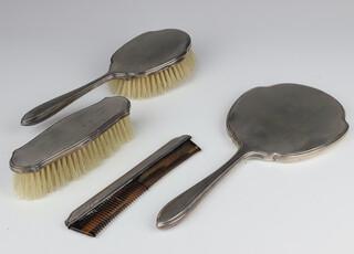 A silver engine turned 3 piece dressing table set comprising hand mirror, hair brush, clothes brush, Sheffield 1938 