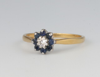 An 18ct yellow metal sapphire and diamond cluster ring 2.4 grams, size M 