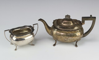 A silver baluster teapot with ebony mounts on pad feet together with a ditto sugar bowl, Sheffield 1916, gross weight 1074 grams 