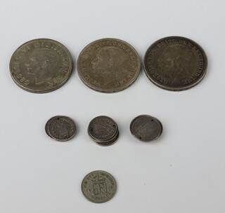 Two 1935 crowns, a 1937 ditto,  a sixpence, 13 Victorian three pence pieces drilled, 105 grams 