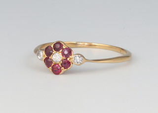 A yellow metal ruby and diamond cluster ring 1.4 grams, size N 1/2 