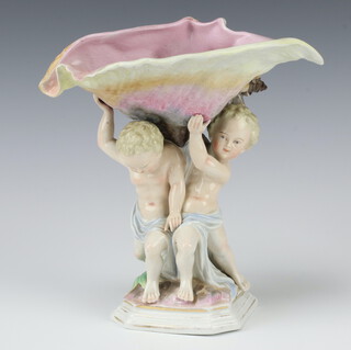 A Sitzendorf centre piece in the form of 2 cherubs holding aloft a shell on an octagonal base 20cm 