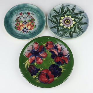 A Moorcroft Limited edition year plate dated 1992 decorated "Passion flower" designed by Sally Tuffin, no.274 of 500, with certificate, 22cm, ditto dated 1991 "Spitalfields Temple Mills" designed by Sally Tuffin, 22cm  and a Moorcroft plate decorated "Anemone" on a green ground impressed marks 25.5cm 