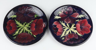 Two Moorcroft plates decorated "Anemone", both with impressed marks 25cm  and 25.5cm together with a  Moorcroft limited edition year dish decorated "Golden Oriole" designed by Rachel Bishop, 59/750, dated 2002 22.5cm 