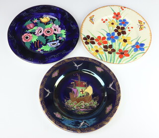 A Maling lustre dish decorated with a galleon 3494 (cracked) 28cm, a ditto decorated flowers 5759 25cm and an Art Deco plate decorated with flowers 25cm 